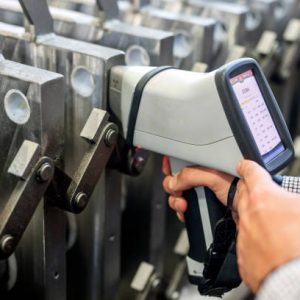 The inspector is material analysis (pmi and xrf) is measuring in stainless steel (ASTM A 304 material) with digital portable material analyzer.